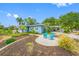 Beautiful single Gathering home with well-manicured lawn, mature landscaping, and a decorative white fence along the front of the property at 401 Whitcomb Blvd, Tarpon Springs, FL 34689