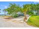 Charming waterfront home with lush landscaping, mature trees, and an inviting driveway at 401 Whitcomb Blvd, Tarpon Springs, FL 34689