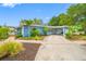 Inviting single-story home with a well-manicured lawn and beautiful landscaping at 401 Whitcomb Blvd, Tarpon Springs, FL 34689