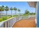 Inviting front porch with wooden flooring, decorative railings, and picturesque views of the waterfront and palm-lined street at 401 Whitcomb Blvd, Tarpon Springs, FL 34689