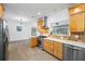 Bright kitchen with stainless steel appliances, gas range, ample wood cabinets, and tile backsplash at 401 Whitcomb Blvd, Tarpon Springs, FL 34689