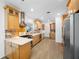 The updated kitchen features stainless steel appliances, light cabinets, and a gas range at 401 Whitcomb Blvd, Tarpon Springs, FL 34689
