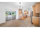 Eat-in kitchen, wood floors, neutral walls, light cabinets, stainless appliances and glass sliding doors at 401 Whitcomb Blvd, Tarpon Springs, FL 34689