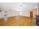 Spacious living room with hardwood floors, fan, and access to a screened patio at 401 Whitcomb Blvd, Tarpon Springs, FL 34689