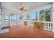 Bright and airy screened porch with wood floors, a ceiling fan, and views of the waterfront at 401 Whitcomb Blvd, Tarpon Springs, FL 34689