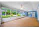 Bright sunroom offering views of lush landscaping and blue exteriors at 401 Whitcomb Blvd, Tarpon Springs, FL 34689