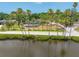 Charming single Gathering home with water view, mature palm trees, manicured lawn, and lovely landscaping at 401 Whitcomb Blvd, Tarpon Springs, FL 34689