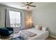 Relaxing bedroom featuring a plush blue chair and a large bright window at 4221 W Spruce St # 1303, Tampa, FL 33607