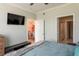 Bedroom with view of dining room, bathroom, and wall-mounted TV at 4221 W Spruce St # 1303, Tampa, FL 33607