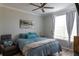 Cozy bedroom featuring a ceiling fan, crown molding and natural light from the bright window at 4221 W Spruce St # 1303, Tampa, FL 33607