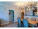 Elegant dining room with modern lighting, a wooden table, and stylish chairs in an open-concept layout at 4221 W Spruce St # 1303, Tampa, FL 33607