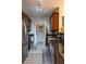 Open kitchen with modern appliances, granite countertops, and dark wood cabinetry, complemented by stylish flooring at 4221 W Spruce St # 1303, Tampa, FL 33607