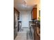 Well-lit kitchen featuring modern appliances, granite countertops, dark cabinets, and stylish flooring at 4221 W Spruce St # 1303, Tampa, FL 33607