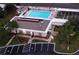 Aerial view of the community building with ample parking, pool, and shuffleboard courts for residents at 4345 Tahitian Gardens Cir # C, Holiday, FL 34691