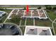 Birds eye view of a condo complex featuring well-maintained lawns and a parking area at 4345 Tahitian Gardens Cir # C, Holiday, FL 34691