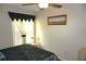 Bedroom with a ceiling fan and window providing plenty of natural light at 4345 Tahitian Gardens Cir # C, Holiday, FL 34691