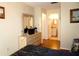Bedroom with wood floors featuring view of dresser with mirror and adjacent bathroom at 4345 Tahitian Gardens Cir # C, Holiday, FL 34691