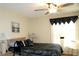 Comfortable bedroom featuring a ceiling fan, window with dark valance and a well-made bed at 4345 Tahitian Gardens Cir # C, Holiday, FL 34691