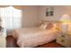 Bedroom featuring wood floors, a window with sheer curtains, and light-colored bedding at 4345 Tahitian Gardens Cir # C, Holiday, FL 34691