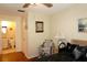 Bedroom view towards the bathroom, featuring wood floors, and decor at 4345 Tahitian Gardens Cir # C, Holiday, FL 34691