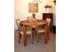 Cozy dining area with round wood table, cushioned chairs, and decorative accents at 4345 Tahitian Gardens Cir # C, Holiday, FL 34691