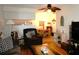 Cozy living room featuring warm hardwood floors, a ceiling fan, and comfortable furnishings at 4345 Tahitian Gardens Cir # C, Holiday, FL 34691
