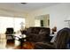Bright living room with large windows, comfortable seating, and a mirrored wall for added space at 4345 Tahitian Gardens Cir # C, Holiday, FL 34691