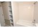 Bathroom boasting a shower-tub combo and built-in shelves at 4513 S Oak Dr # Q31B, Tampa, FL 33611