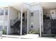 Condominium exterior featuring staircases leading to multiple units and neutral color scheme at 4513 S Oak Dr # Q31B, Tampa, FL 33611