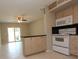 Well-lit kitchen with appliances and a breakfast bar open to the dining area at 4513 S Oak Dr # Q31B, Tampa, FL 33611