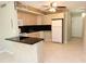 Kitchen with an island and ceiling fan with easy access to the appliances and door at 4513 S Oak Dr # Q31B, Tampa, FL 33611