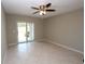 Open living area with tile flooring, ceiling fan, and sliding doors that provide natural light at 4513 S Oak Dr # Q31B, Tampa, FL 33611
