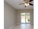 Bright living room features tile floors, ceiling fan, and sliding glass doors to the backyard at 4513 S Oak Dr # Q31B, Tampa, FL 33611
