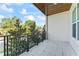 Spacious balcony with black iron railings and tree views at 4911 N Nebraska Ave, Tampa, FL 33603