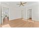 Bedroom with light wood floors, white walls, and multiple doorways at 4911 N Nebraska Ave, Tampa, FL 33603
