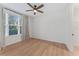Bright bedroom with hardwood floors, a modern ceiling fan, and natural light from the window at 4911 N Nebraska Ave, Tampa, FL 33603