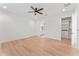 Bedroom with hardwood floors and ceiling fan with adjacent ensuite and walk-in closet at 4911 N Nebraska Ave, Tampa, FL 33603