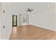 A serene bedroom offers natural light, balcony access, and modern ceiling fan enhancing its tranquil atmosphere at 4911 N Nebraska Ave, Tampa, FL 33603