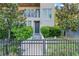 Inviting front entrance with a black metal fence, lush landscaping, and a modern facade at 4911 N Nebraska Ave, Tampa, FL 33603
