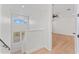 Bright hallway featuring hardwood floors, recessed lighting, and staircase with natural light at 4911 N Nebraska Ave, Tampa, FL 33603