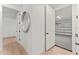 Hallway with wood floors, two doors, a view into a garage, and white paint at 4911 N Nebraska Ave, Tampa, FL 33603