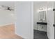 Hallway leads to a stylish powder room with modern fixtures at 4911 N Nebraska Ave, Tampa, FL 33603