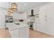 Modern kitchen featuring white cabinetry, stainless steel appliances, and a spacious island at 4911 N Nebraska Ave, Tampa, FL 33603