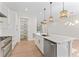 The kitchen boasts white cabinets, stainless steel appliances, a large island, and an open-concept design at 4911 N Nebraska Ave, Tampa, FL 33603
