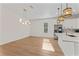 Spacious living area with modern lighting, open floor plan, and a view of the stylish kitchen at 4911 N Nebraska Ave, Tampa, FL 33603