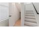 Staircase featuring wood steps with modern railing and a storage space beneath at 4911 N Nebraska Ave, Tampa, FL 33603