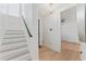 White staircase featuring wood steps with modern railing and light fixtures at 4911 N Nebraska Ave, Tampa, FL 33603