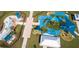 Overhead perspective highlights the community's dual water park and playground, complemented by ample shaded seating at 5112 Lanai Way, Tampa, FL 33624