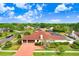 Aerial view showcasing a home with a paver driveway and mature landscaping at 5112 Lanai Way, Tampa, FL 33624