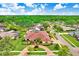 Aerial view of a lovely neighborhood featuring a home with mature trees and a red brick driveway at 5112 Lanai Way, Tampa, FL 33624